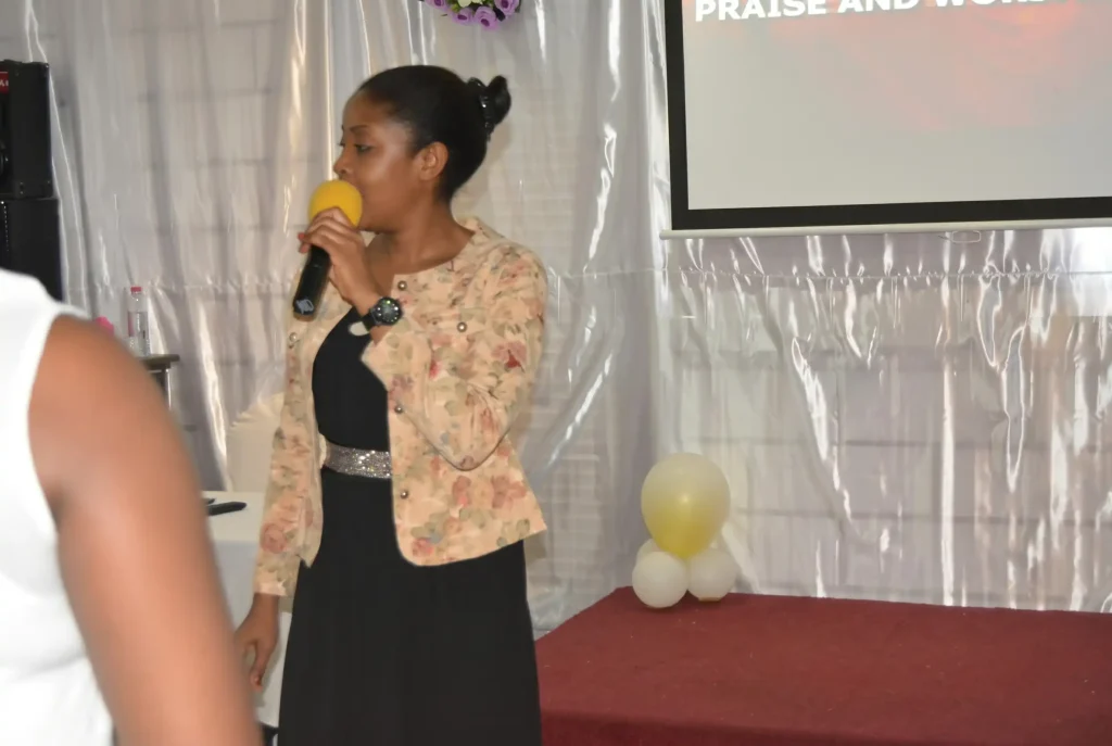 Vanessa Musenja preaching with a microphone