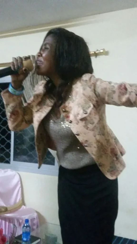 A worshipper with hands raised in the service